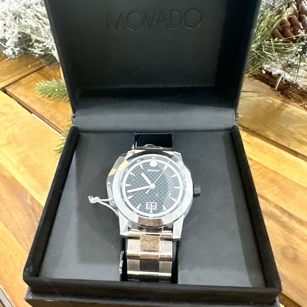 MOVADO VIZIO WITH 44MM BLACK CARBON FIBER
DIAL. 0607050. Brand new never used.